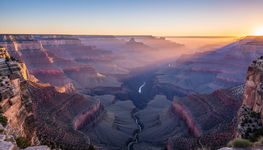 People silhouetted at the South Rim of the Grand Canyon during sunrise